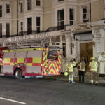 Fire Crews attend the Mansion Lions Hotel after people were spotted on the roof.